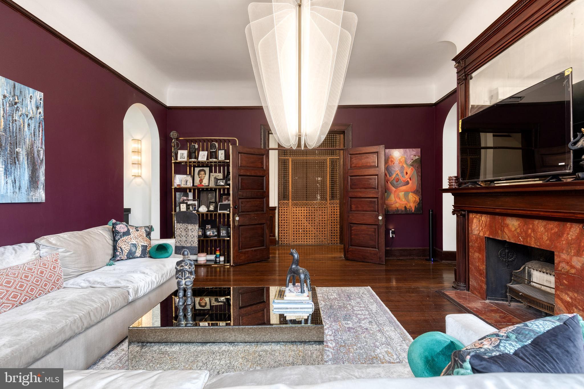 2452 Eutaw Place Baltimore, MD 21217 - Photo 33 of 75 a living room with furniture a fireplace and a flat screen tv