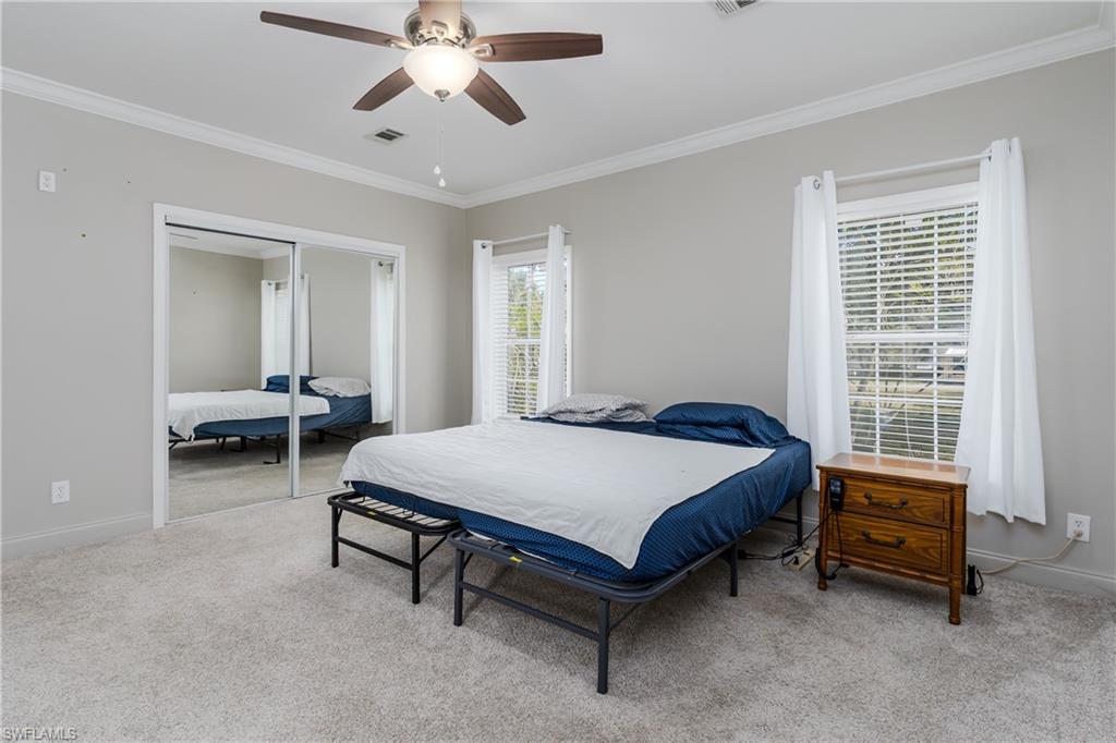 104 Rookery Road Naples, FL 34114 - Photo 12 of 32 a bed room with a bed and a window