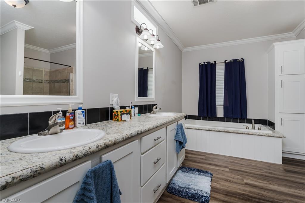 104 Rookery Road Naples, FL 34114 - Photo 14 of 32 a bathroom with a granite countertop sink and a mirror