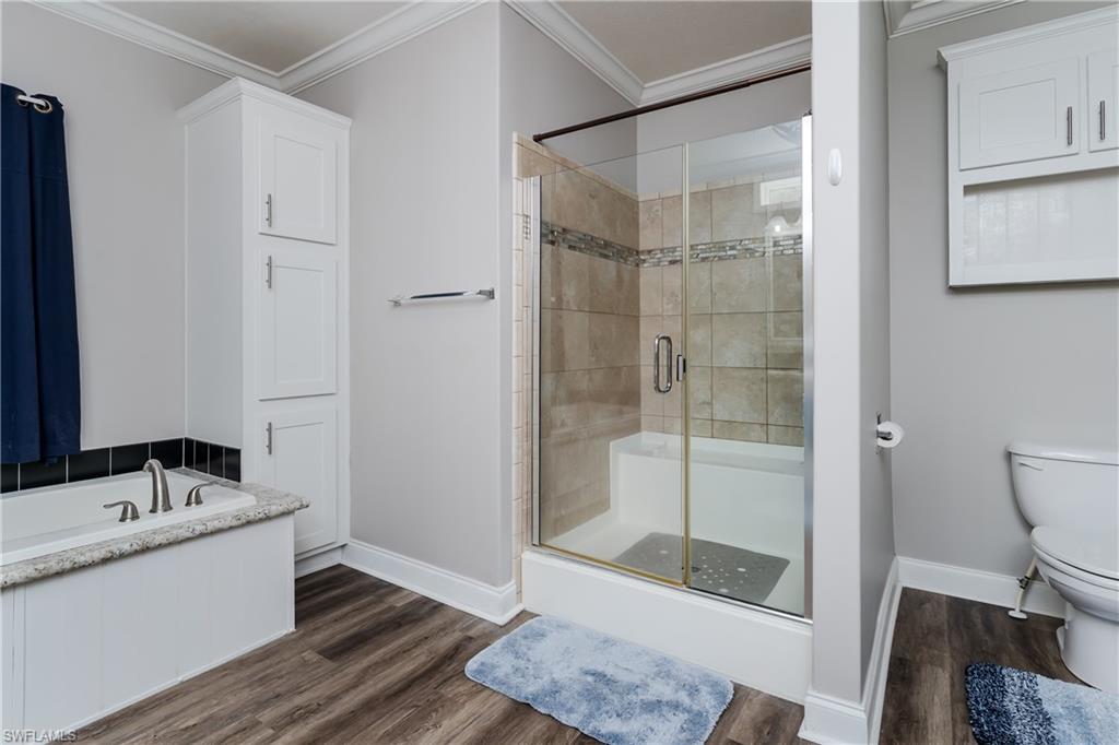 104 Rookery Road Naples, FL 34114 - Photo 15 of 32 a bathroom with a granite countertop sink a toilet and shower