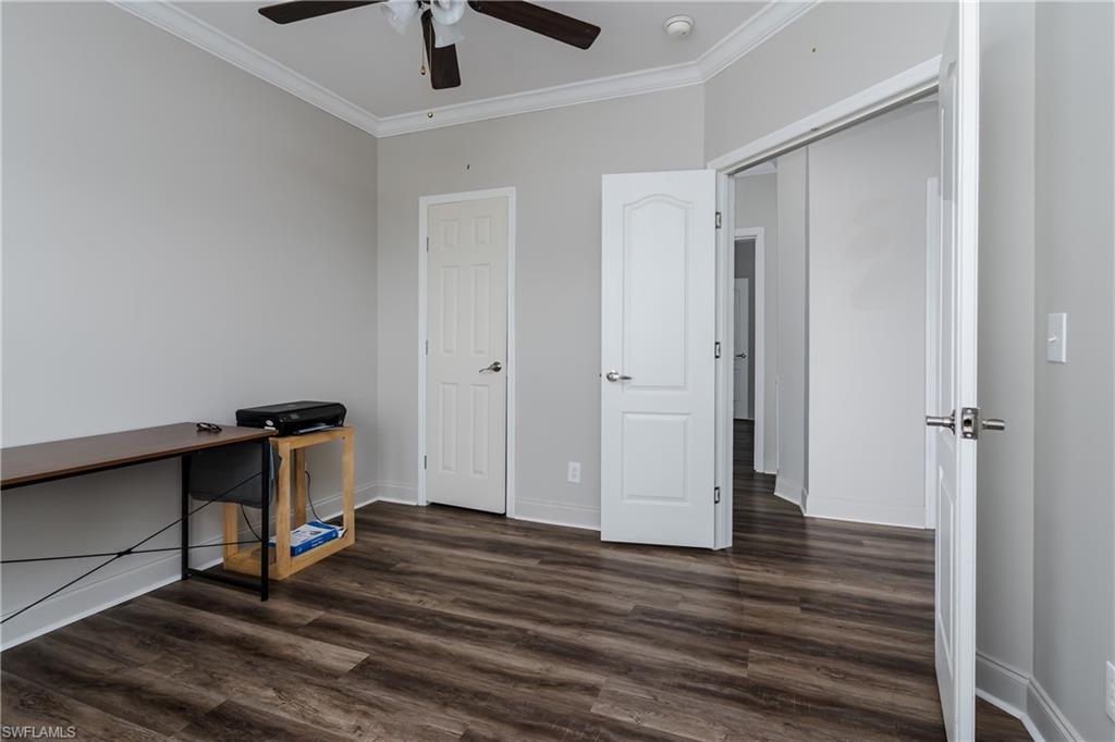 104 Rookery Road Naples, FL 34114 - Photo 17 of 32 a room with wooden floor and ceiling fan