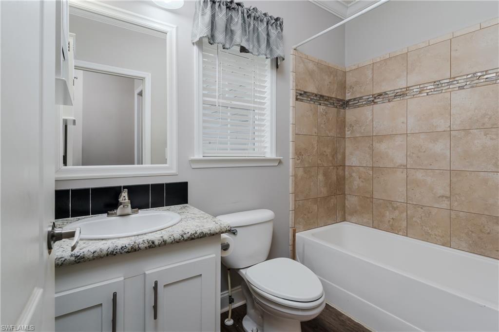 104 Rookery Road Naples, FL 34114 - Photo 18 of 32 a bathroom with a sink a toilet and shower