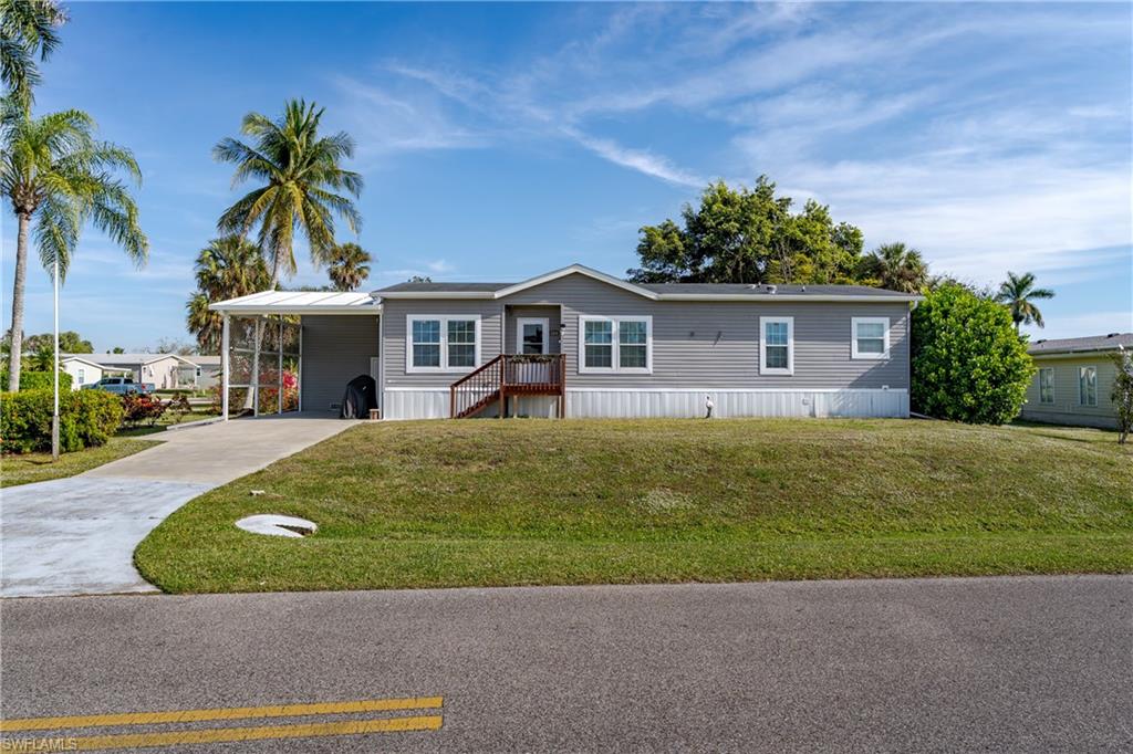 104 Rookery Road Naples, FL 34114 - Photo 2 of 32 a front view of a house with garden
