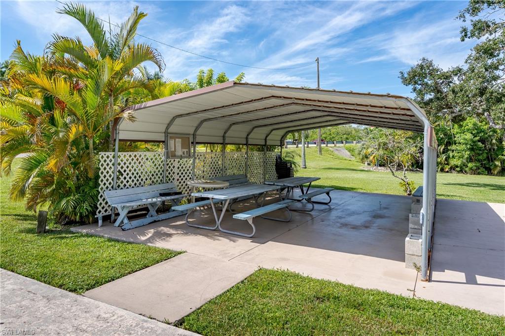 104 Rookery Road Naples, FL 34114 - Photo 28 of 32 a backyard of a house with outdoor seating