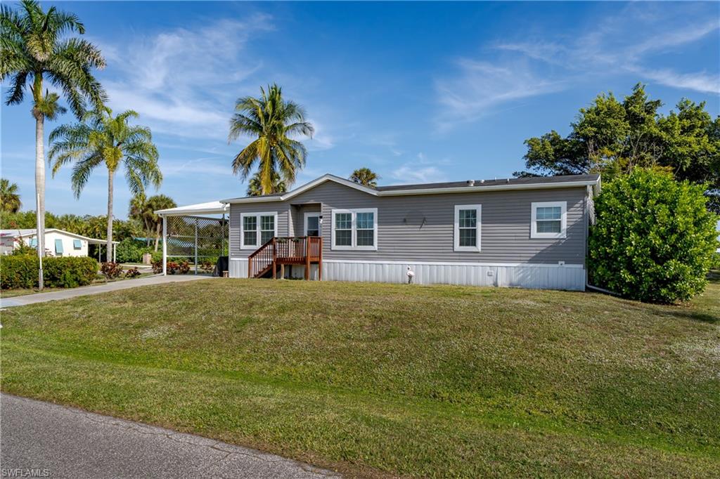 104 Rookery Road Naples, FL 34114 - Photo 3 of 32 a front view of a house with a garden