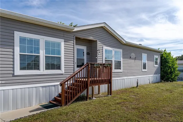 a view of a house with wooden floor in a backyard