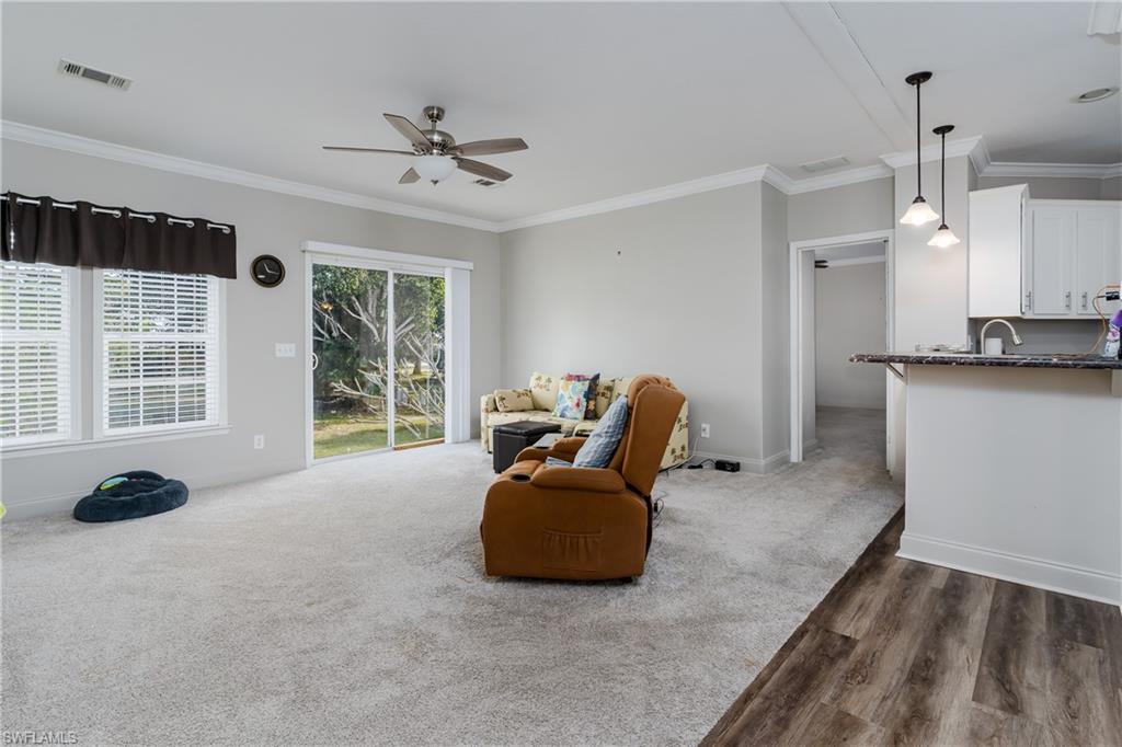 104 Rookery Road Naples, FL 34114 - Photo 5 of 32 a living room with furniture and a large window