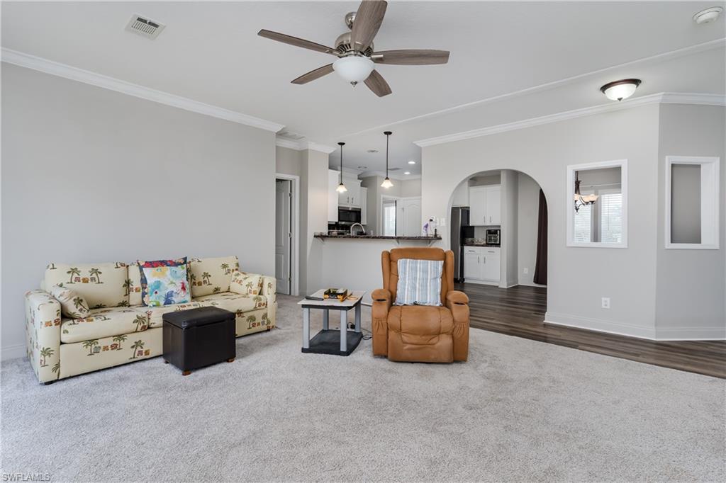 104 Rookery Road Naples, FL 34114 - Photo 6 of 32 a living room with furniture and kitchen view