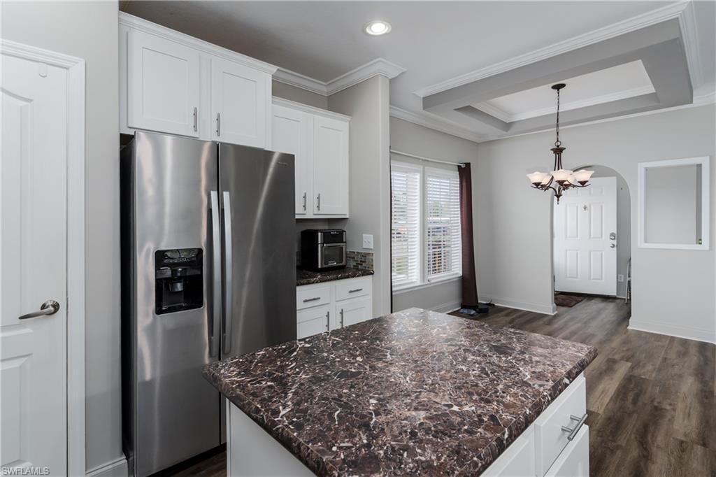 104 Rookery Road Naples, FL 34114 - Photo 9 of 32 a kitchen with stainless steel appliances granite countertop a refrigerator and a granite counter tops