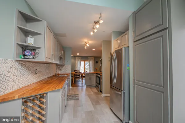 a kitchen with stainless steel appliances granite countertop a refrigerator and a sink