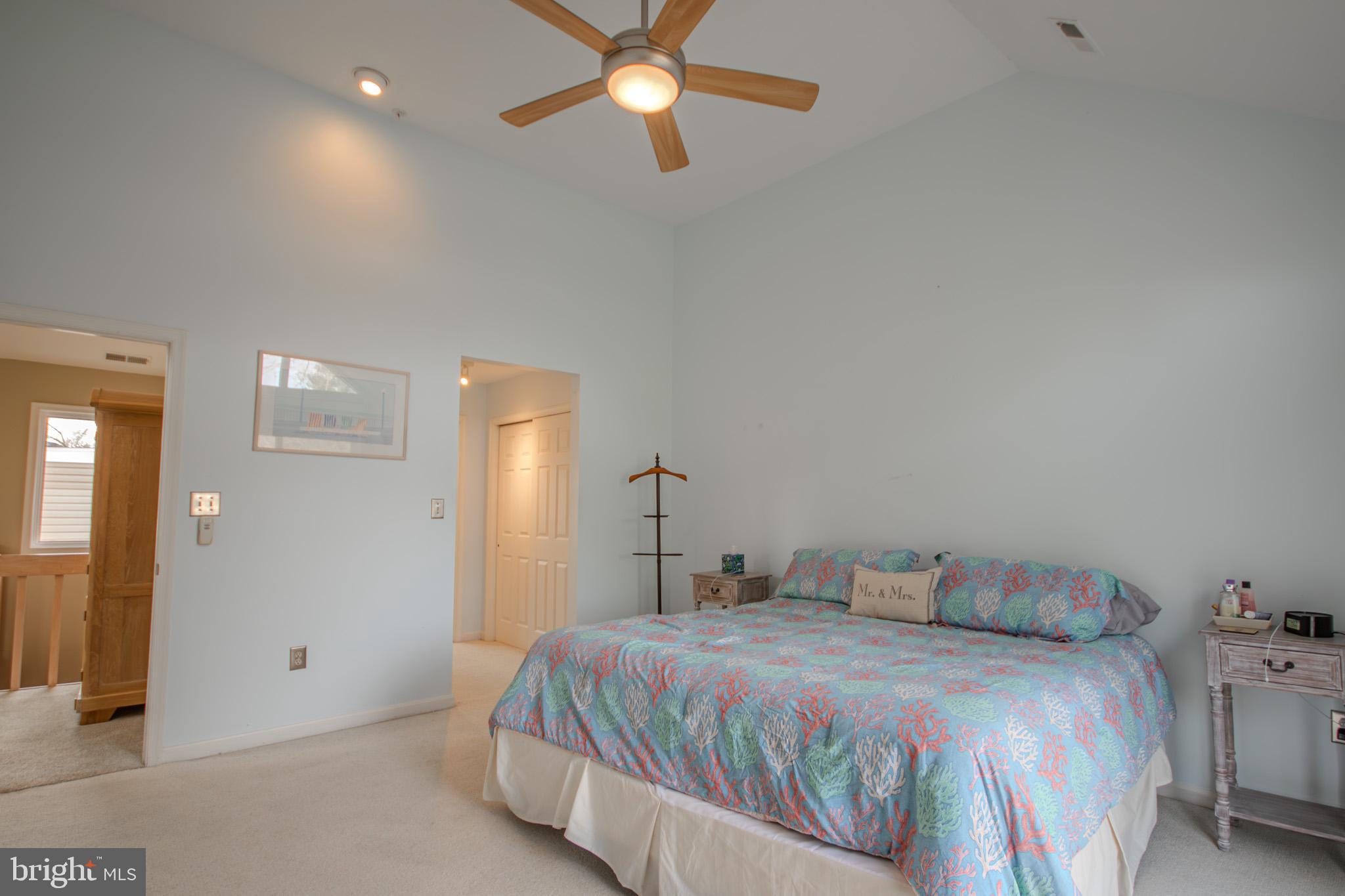 11610 Masters Lane, Unit 115 Berlin, MD 21811 - Photo 17 of 46 a bedroom with a bed and a chandelier