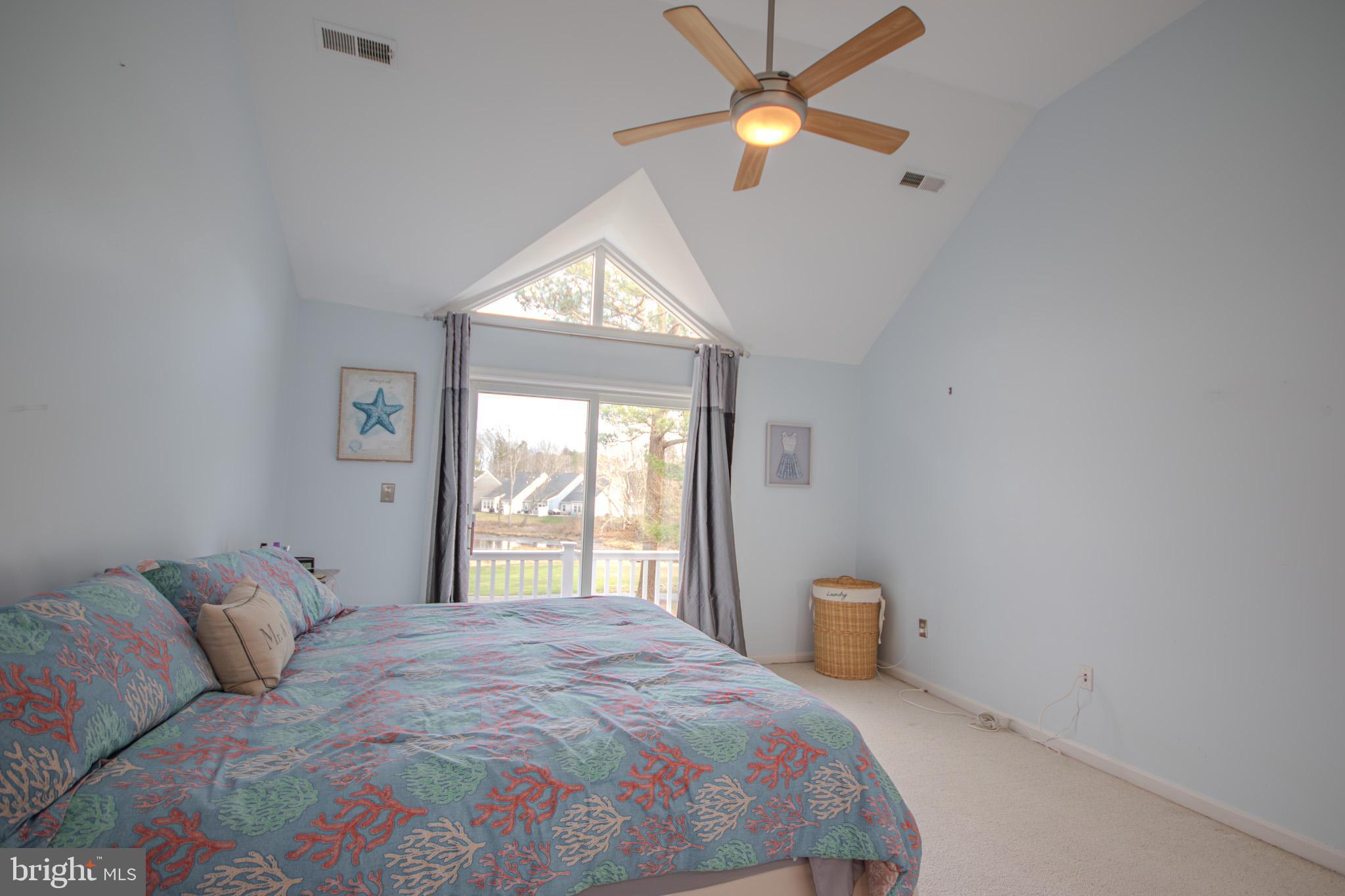 11610 Masters Lane, Unit 115 Berlin, MD 21811 - Photo 18 of 46 a bedroom with a bed and a window