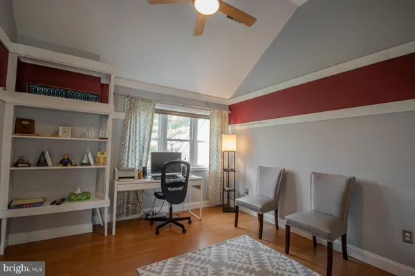 a view of a workspace with furniture and a window