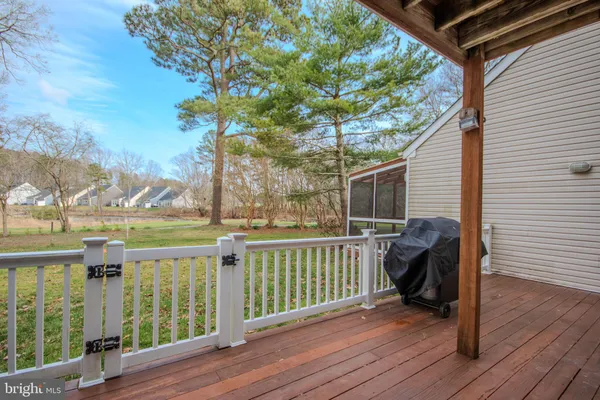 a view of a porch with furniture and wooden floor