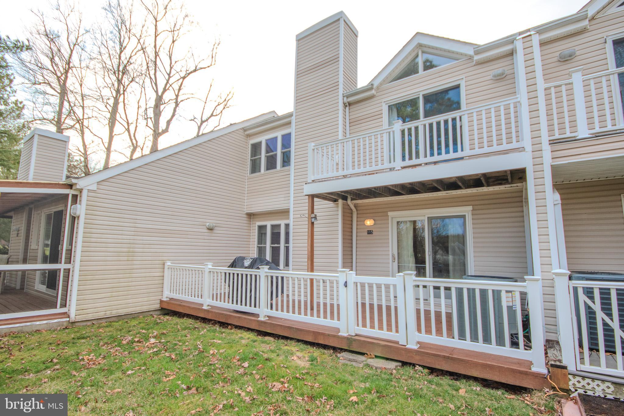 11610 Masters Lane, Unit 115 Berlin, MD 21811 - Photo 37 of 46 a view of a house with a small yard and wooden fence