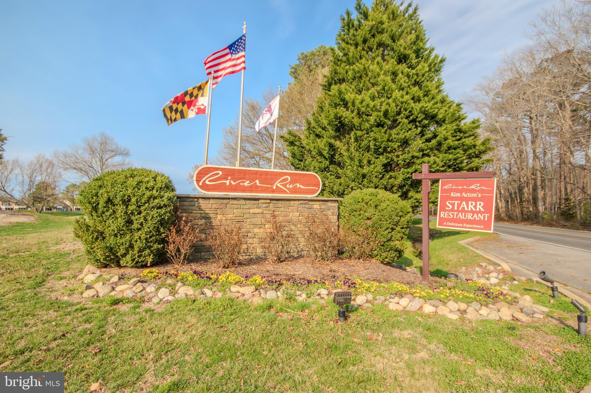 11610 Masters Lane, Unit 115 Berlin, MD 21811 - Photo 45 of 46 a view of outdoor space with signage and flags