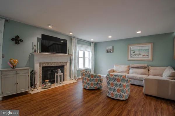 a living room with furniture fireplace and flat screen tv