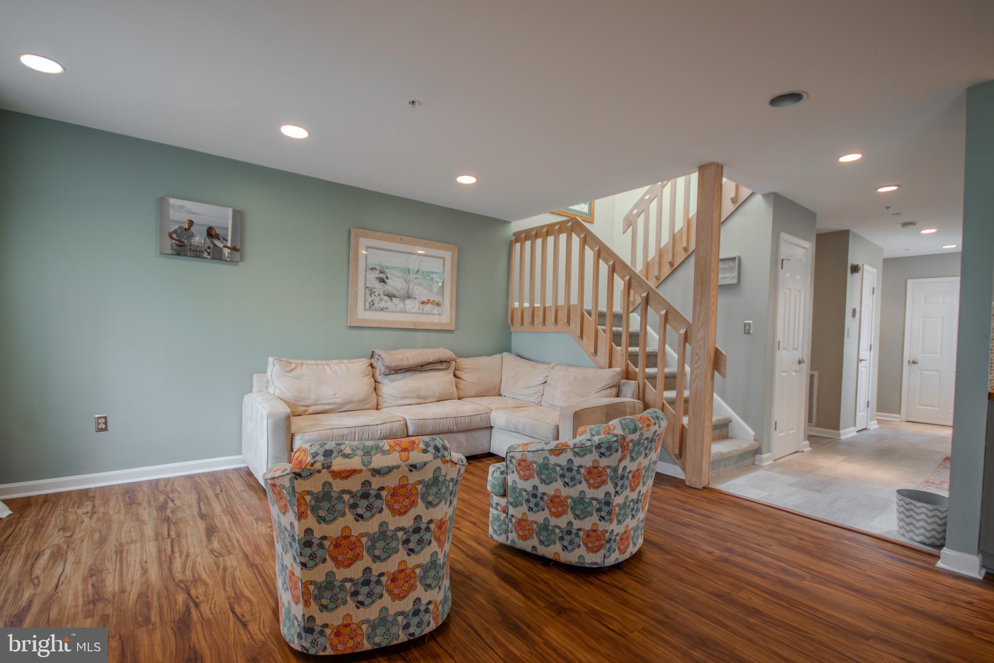 11610 Masters Lane, Unit 115 Berlin, MD 21811 - Photo 7 of 46 a living room with furniture and a wooden floor