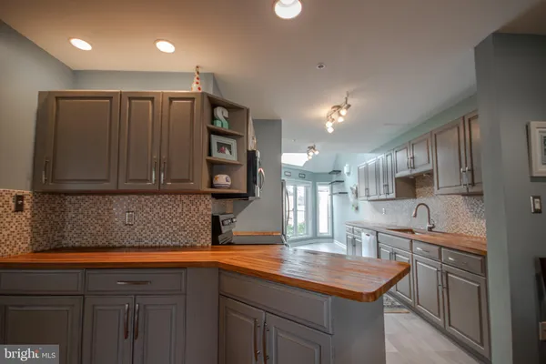 a kitchen with a sink cabinets and window