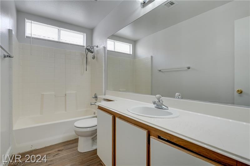 9660 Crystal Ridge Road Las Vegas, NV 89123 - Photo 16 of 18 A well-appointed bathroom features a practical vanity with an integrated sink and a full-size mirror.