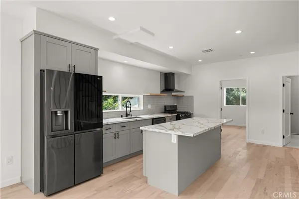 a kitchen with refrigerator a sink and cabinets