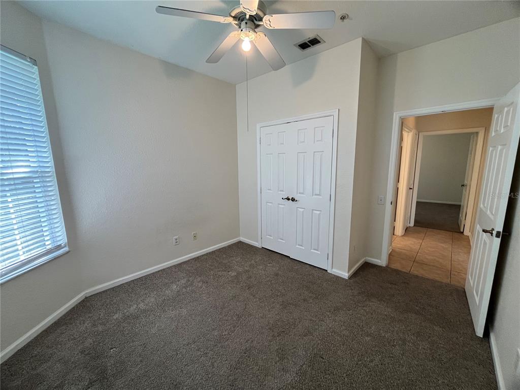 588 Brantley Terrace Way, Unit 309 Altamonte Springs, FL 32714 - Photo 11 of 17 an empty room with closet and a ceiling fan