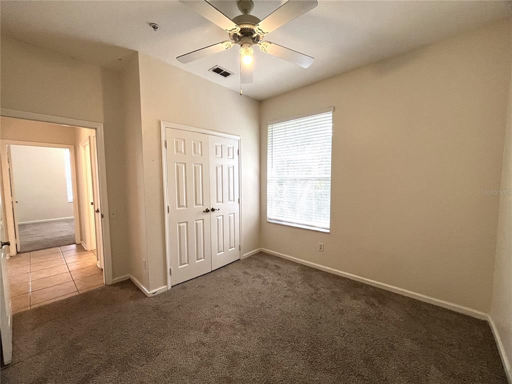 588 Brantley Terrace Way, Unit 309 Altamonte Springs, FL 32714 - Photo 12 of 17 an empty room with windows and fan