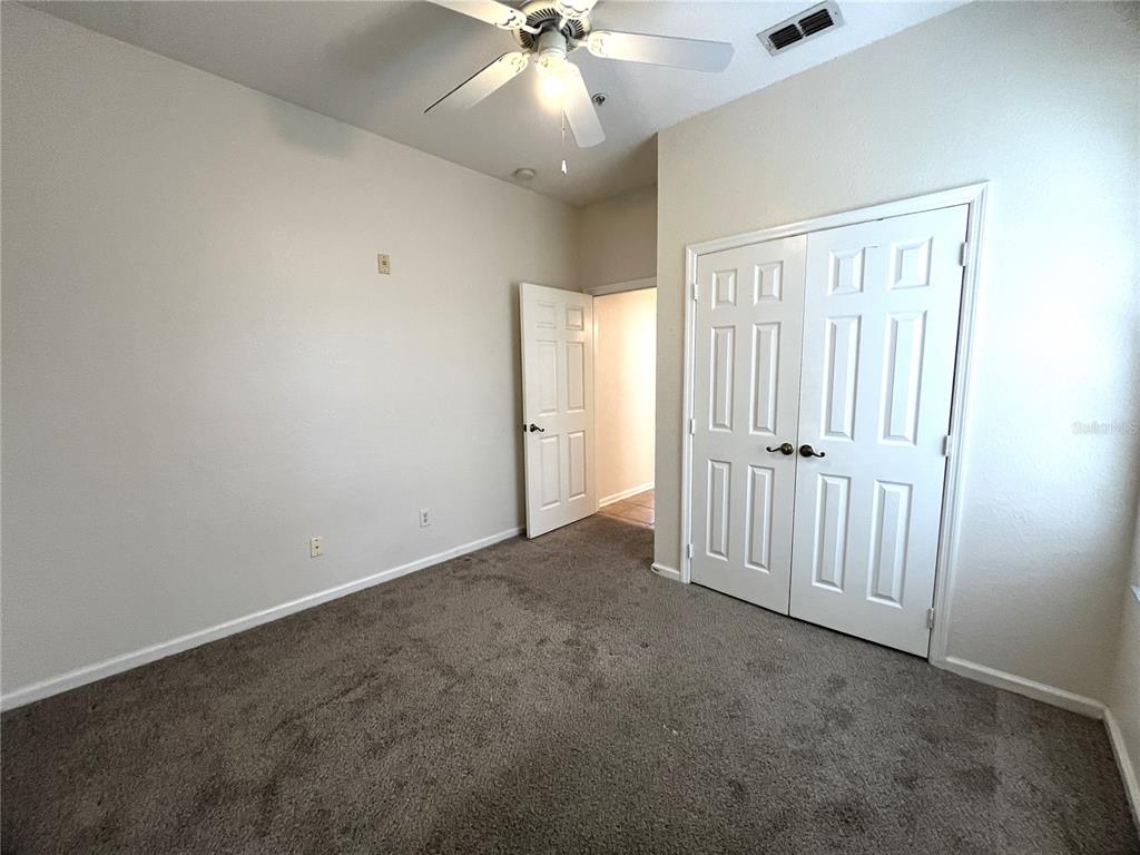 588 Brantley Terrace Way, Unit 309 Altamonte Springs, FL 32714 - Photo 13 of 17 an empty room with fan and entrance