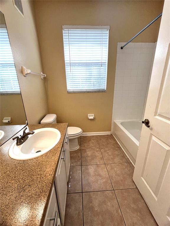 588 Brantley Terrace Way, Unit 309 Altamonte Springs, FL 32714 - Photo 14 of 17 a bathroom with a sink a toilet and a mirror