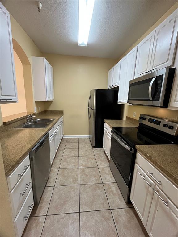 588 Brantley Terrace Way, Unit 309 Altamonte Springs, FL 32714 - Photo 5 of 17 a kitchen with cabinets and steel appliances