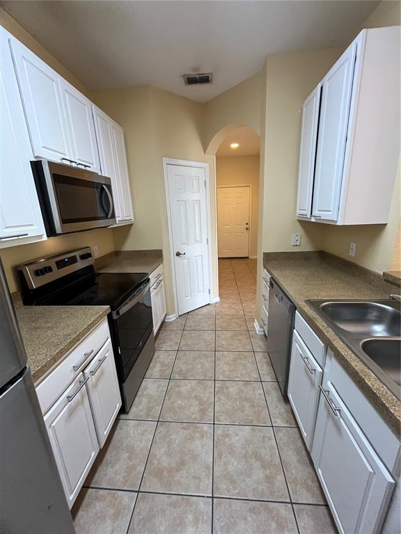 588 Brantley Terrace Way, Unit 309 Altamonte Springs, FL 32714 - Photo 6 of 17 a kitchen with a stove microwave and sink
