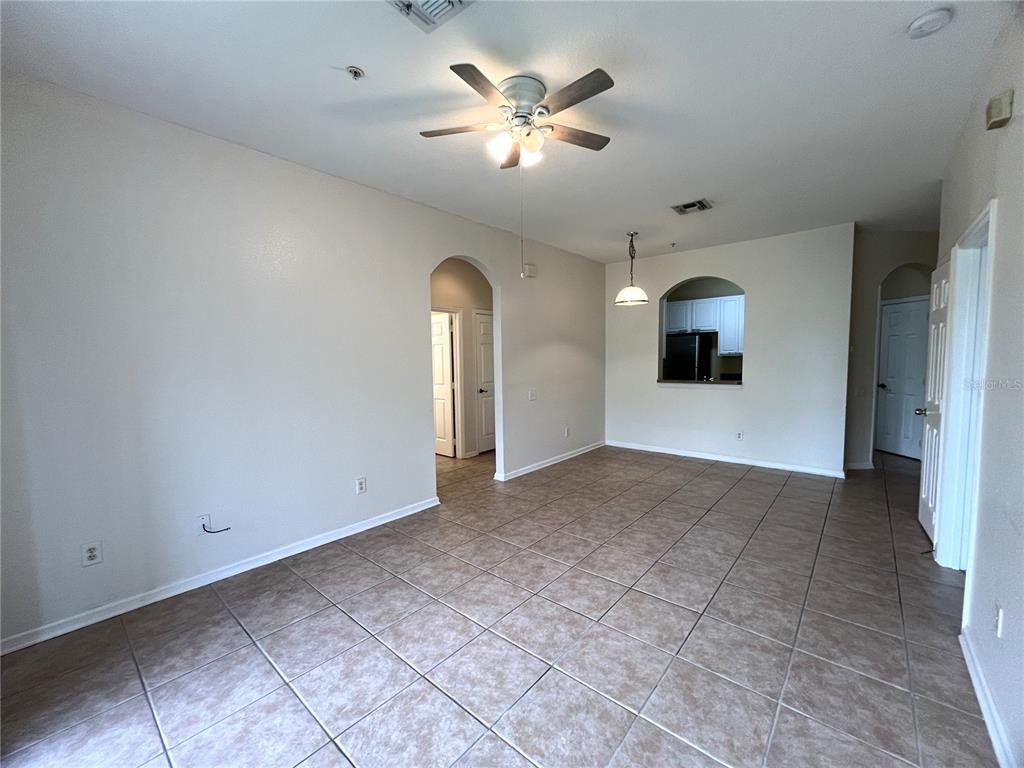 588 Brantley Terrace Way, Unit 309 Altamonte Springs, FL 32714 - Photo 8 of 17 a view of a livingroom with a ceiling fan and window