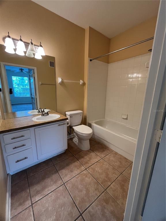 588 Brantley Terrace Way, Unit 309 Altamonte Springs, FL 32714 - Photo 10 of 17 a bathroom with a sink a toilet and shower