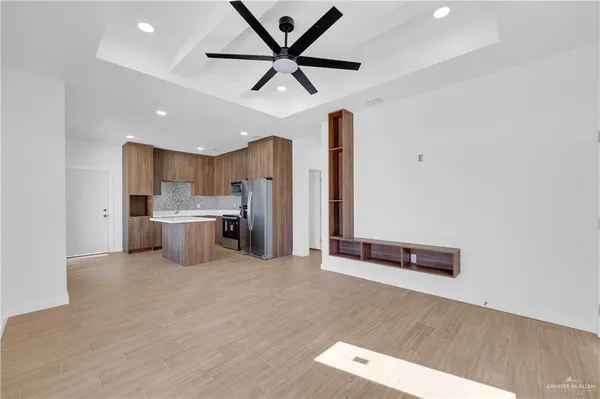 a view of a kitchen with a sink cabinets and stainless steel appliances