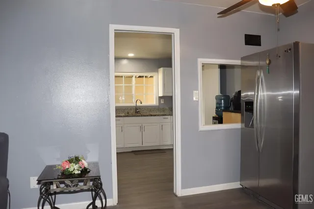 a hallway with a sink and cabinets