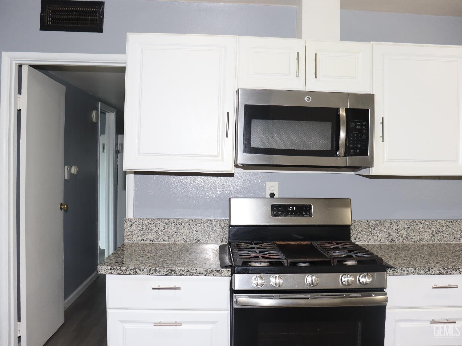 Undisclosed Address New Cuyama, CA 93254 - Photo 31 of 45 a kitchen with granite countertop a stove and a microwave