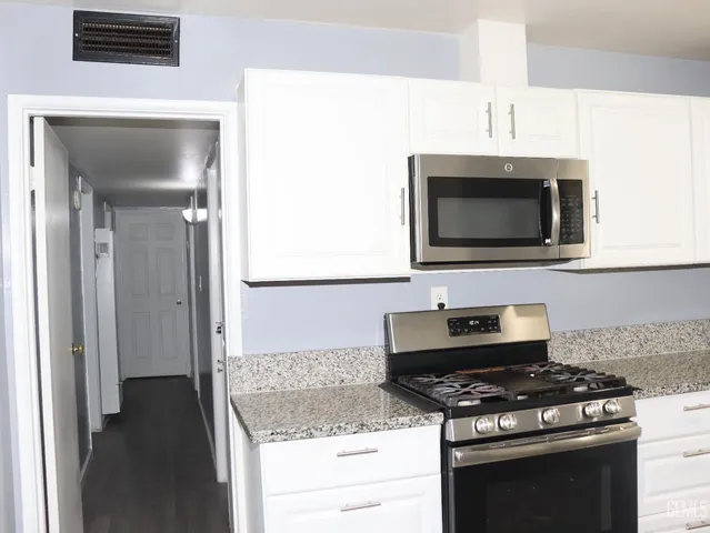 a kitchen with a stove and a microwave