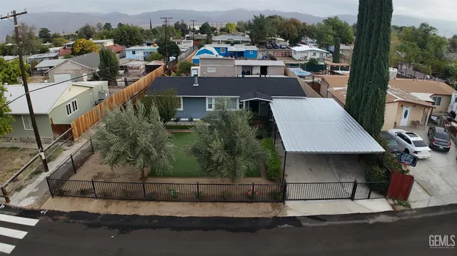 an aerial view of a house with a yard basket ball court and outdoor seating