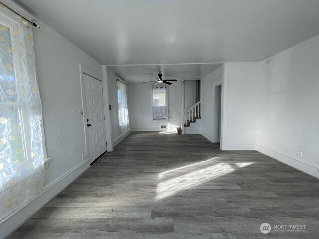 303 Methow Street Wenatchee, WA 98801 - Photo 4 of 14 a view of a hallway with wooden floor and a window