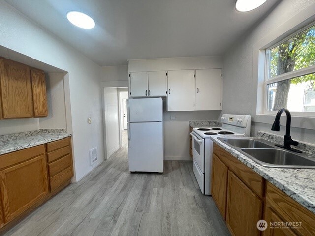 303 Methow Street Wenatchee, WA 98801 - Photo 6 of 14 a kitchen that has a sink stainless steel appliances a counter space and a window