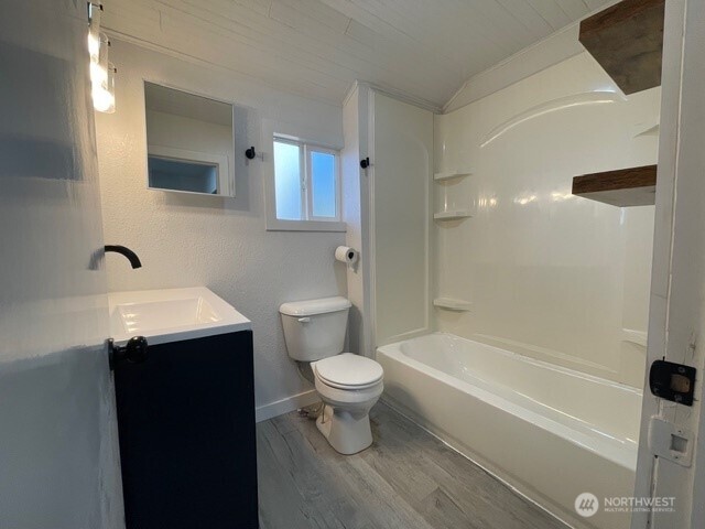 303 Methow Street Wenatchee, WA 98801 - Photo 7 of 14 a bathroom with a sink a toilet and shower