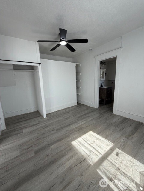 303 Methow Street Wenatchee, WA 98801 - Photo 8 of 14 an empty room with wooden floor cabinet and windows