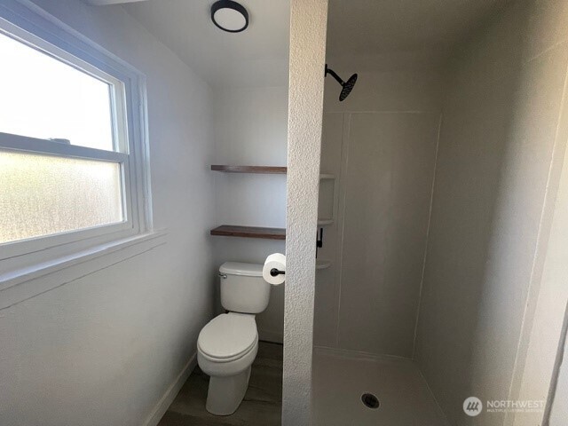 303 Methow Street Wenatchee, WA 98801 - Photo 10 of 14 a white toilet sitting next to a bathroom sink
