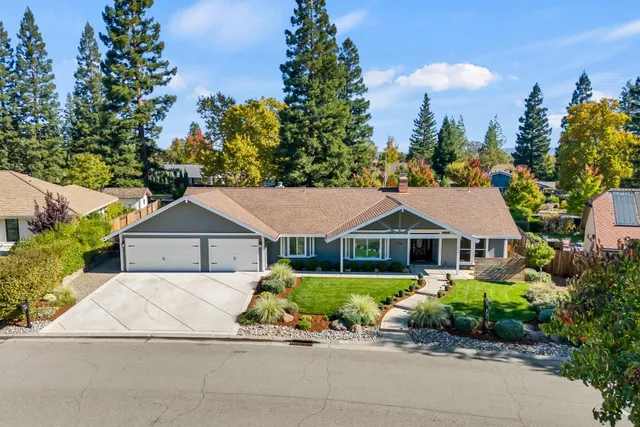 a house with green field in front of it
