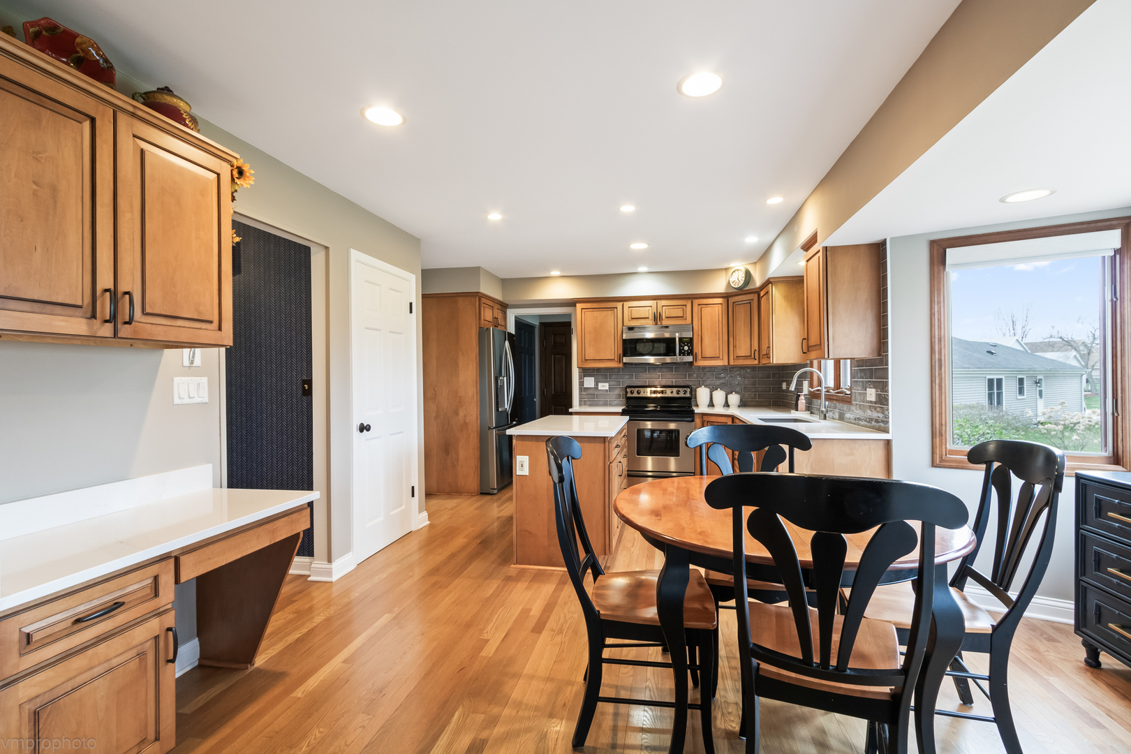 3963 Bordeaux Drive Hoffman Estates, IL 60192 - Photo 12 of 33 a dining room with stainless steel appliances kitchen island granite countertop a dining table chairs and granite counter tops