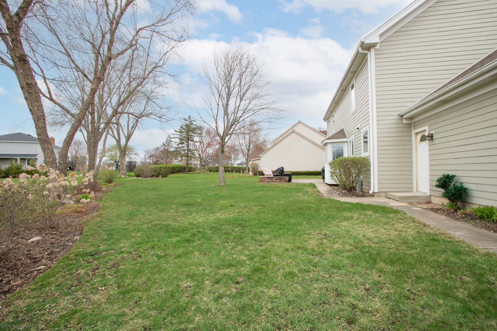 3963 Bordeaux Drive Hoffman Estates, IL 60192 - Photo 30 of 33 a view of a backyard with a large tree