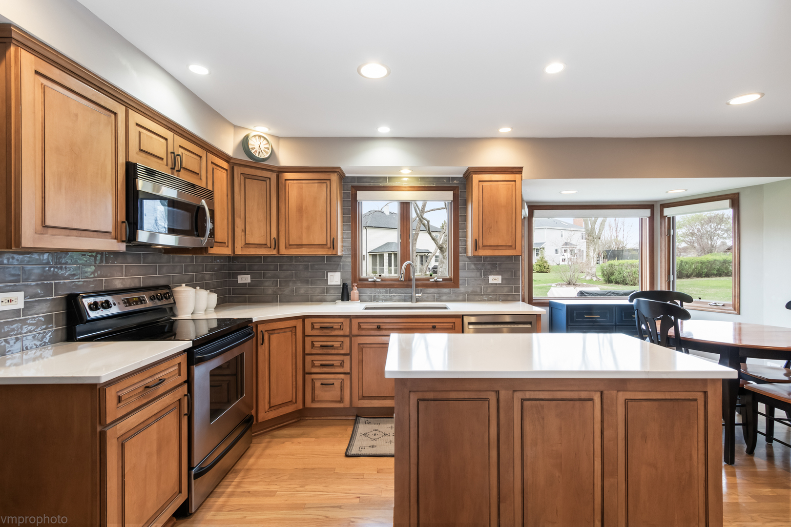3963 Bordeaux Drive Hoffman Estates, IL 60192 - Photo 9 of 33 a kitchen with stainless steel appliances wooden cabinets a sink and a stove
