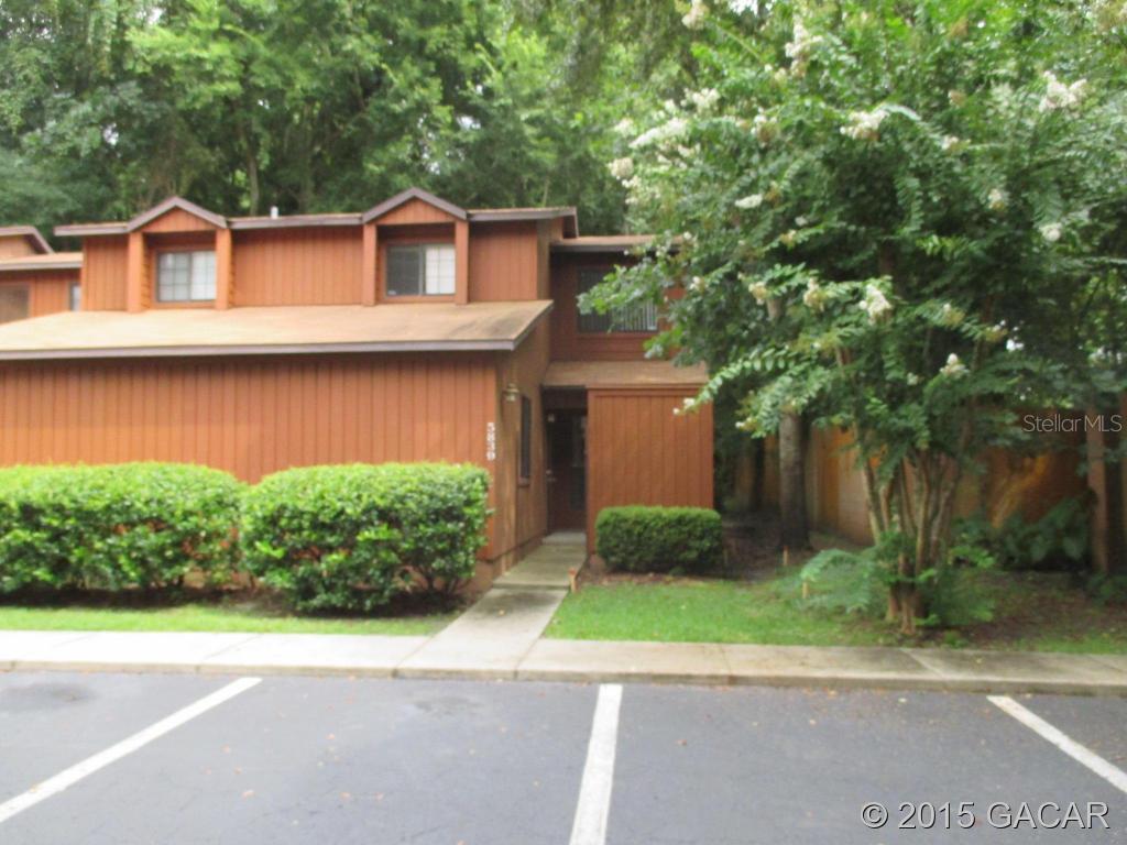 5839 Southwest 9th Place Gainesville, FL 32607 - Photo 1 of 1 a front view of a house with a yard and a garage