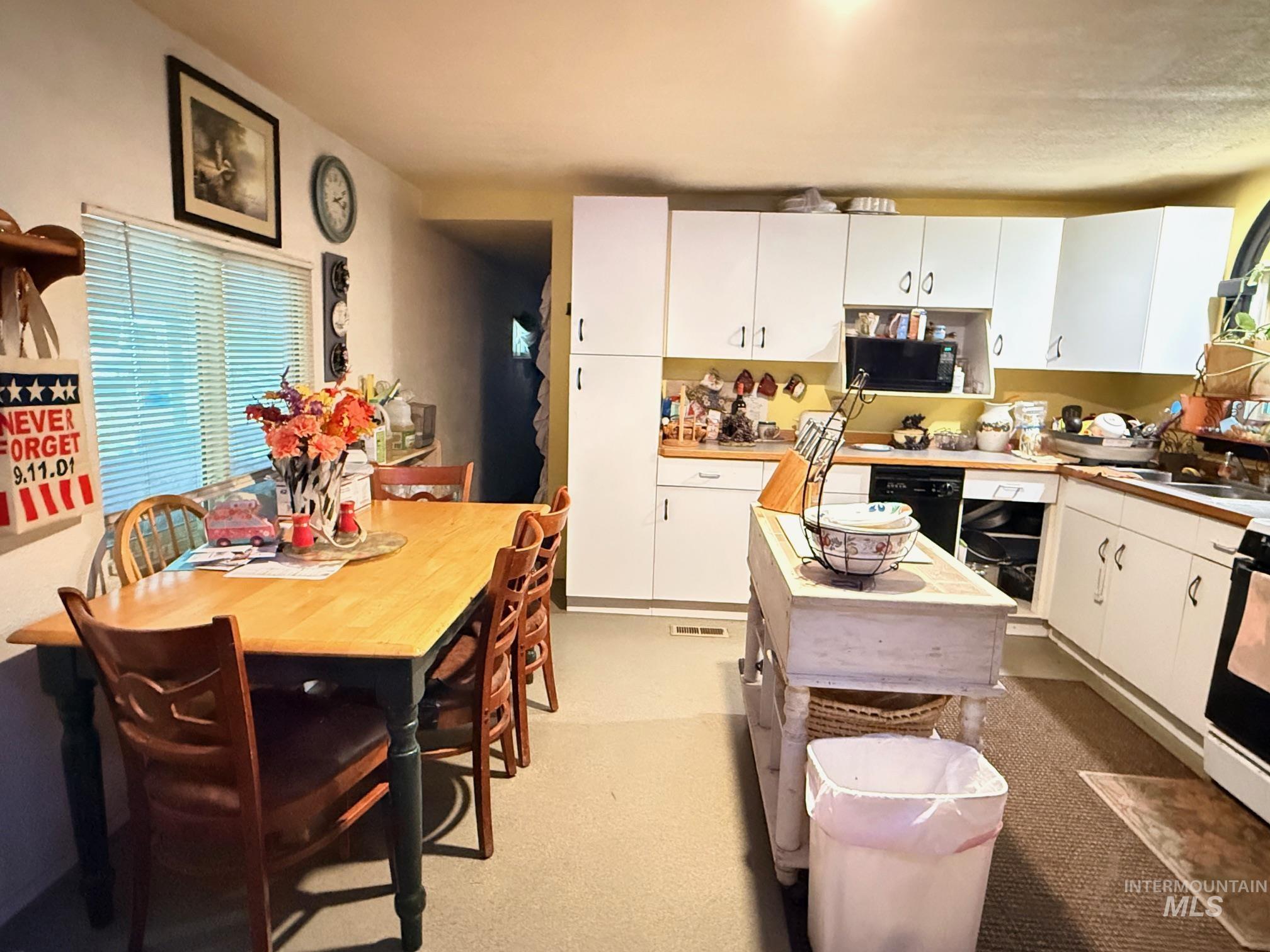 5742 Grangemont Road Orofino, ID 83544 - Photo 7 of 25 Kitchen with white cabinetry, wood-finish countertops, and black appliances
