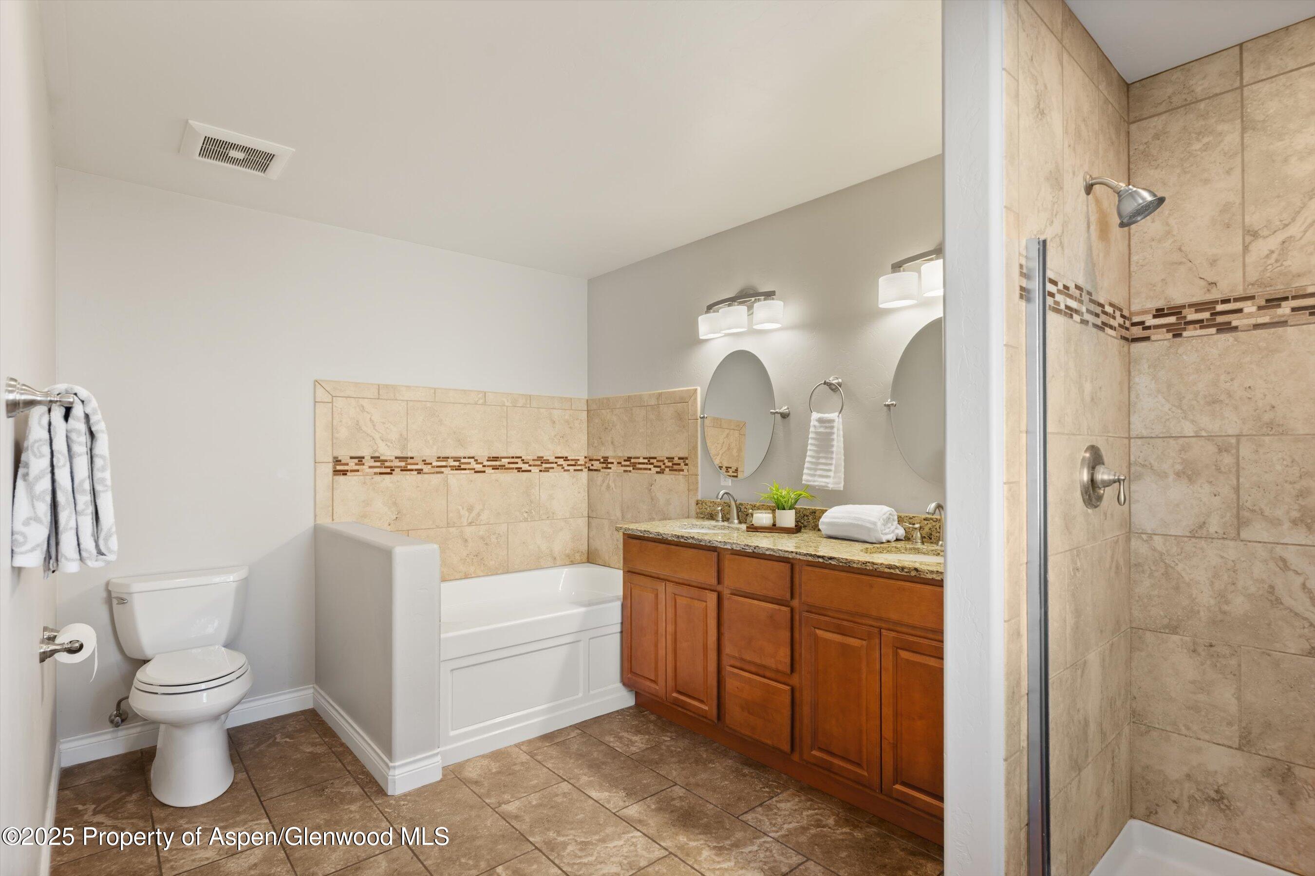 200 Castle Ridge Drive New Castle, CO 81647 - Photo 13 of 24 a bathroom with a granite countertop toilet a sink and a mirror